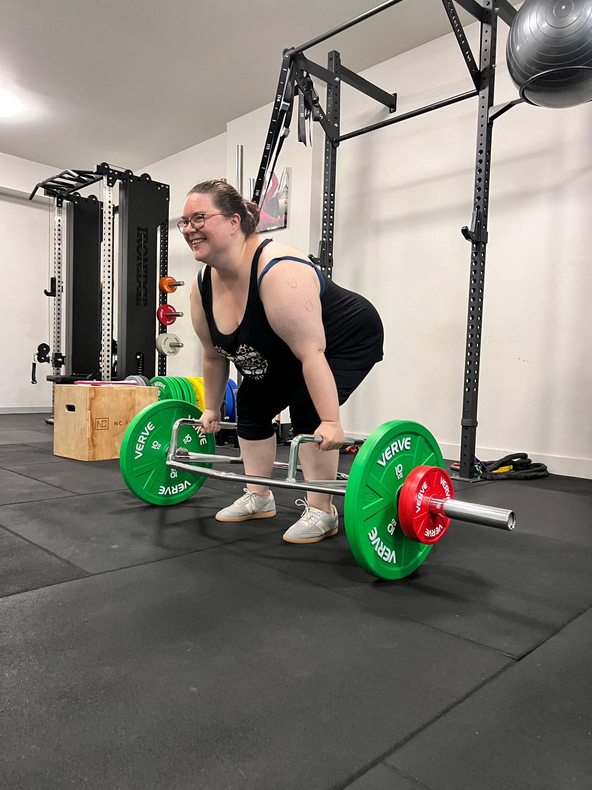 Member performing a trap bar deadlift