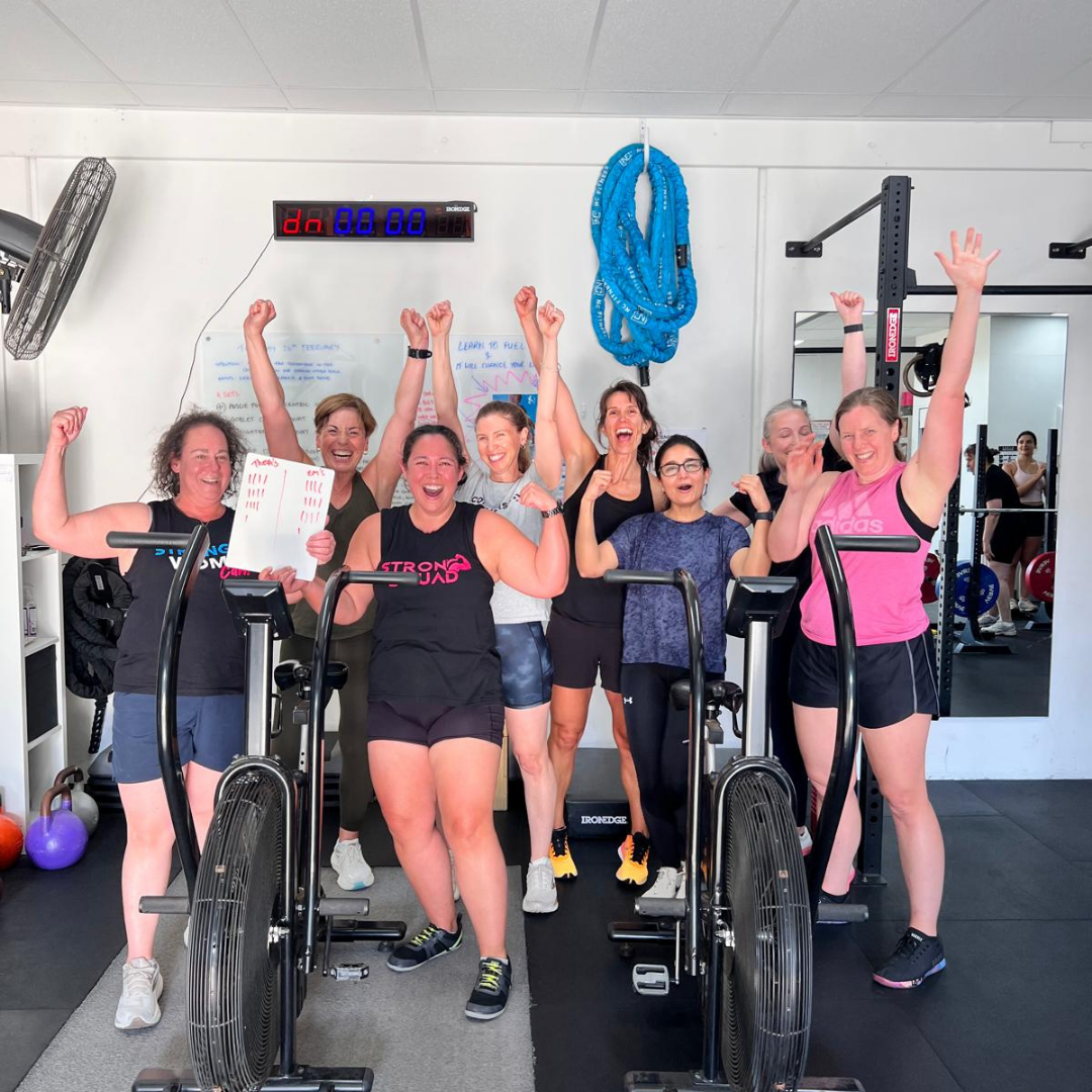Group of members cheering together after a class