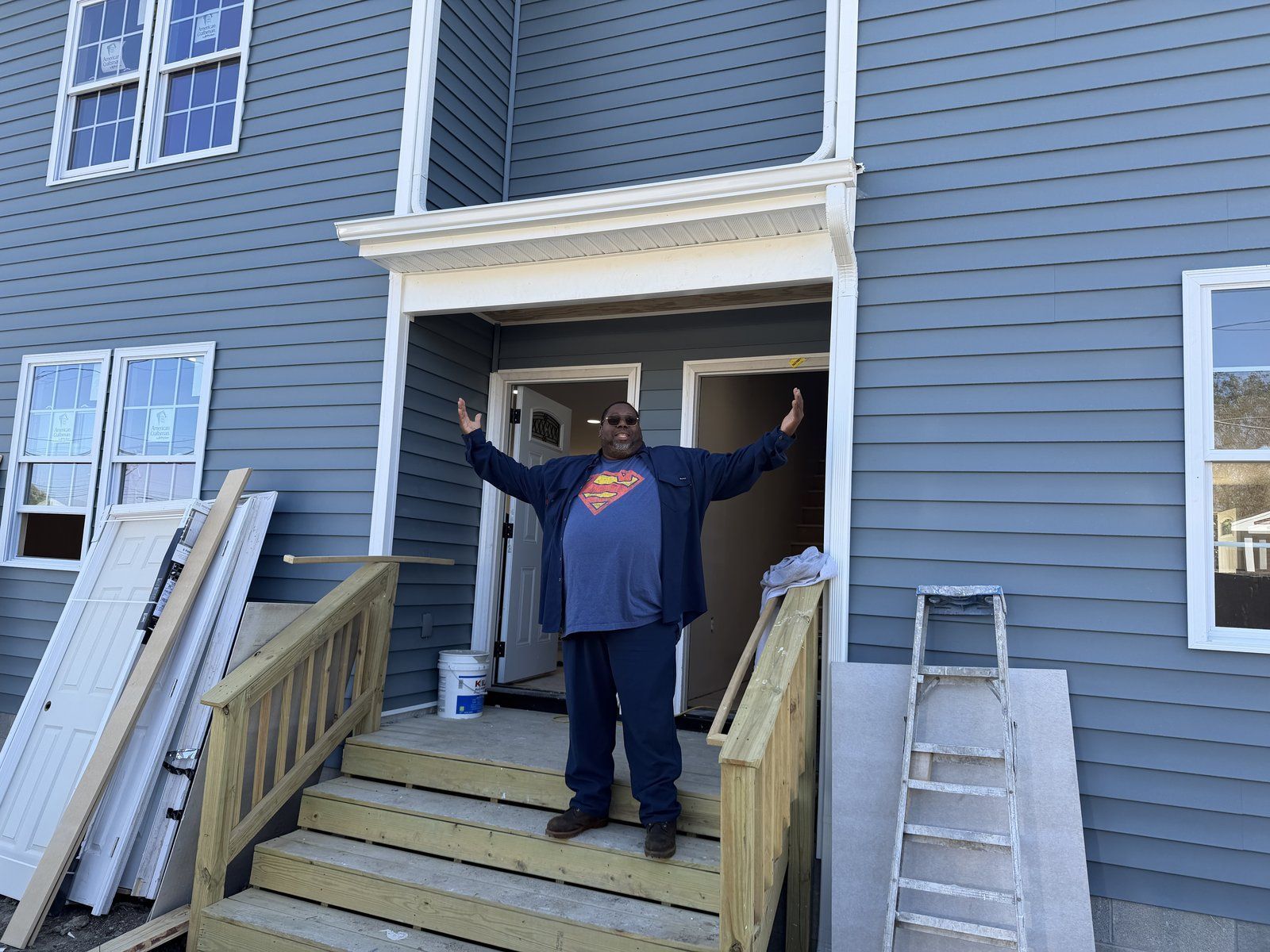 Completed custom home with blue siding and a front entry