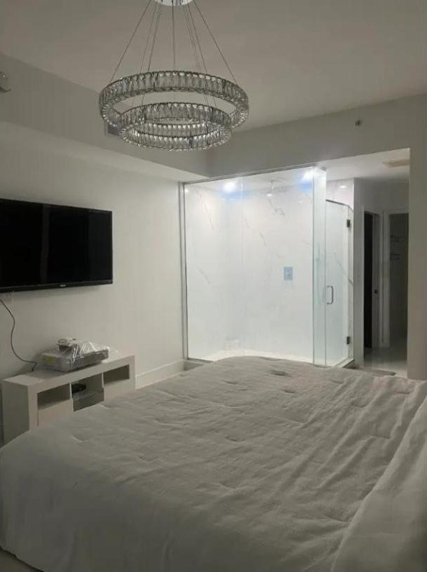 Bedroom with a frosted glass shower wall