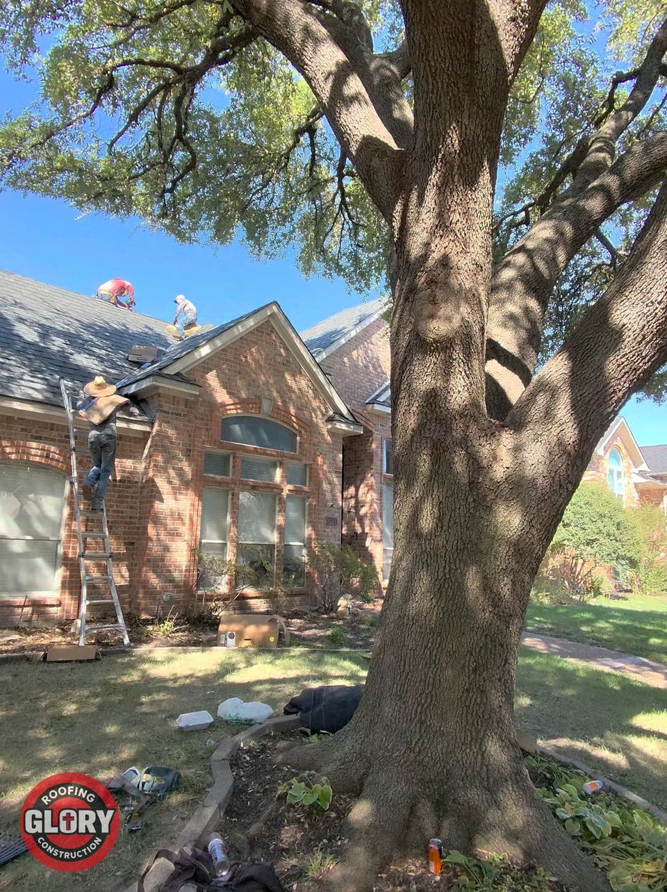 Roofing Glory crew on a brick home's roof