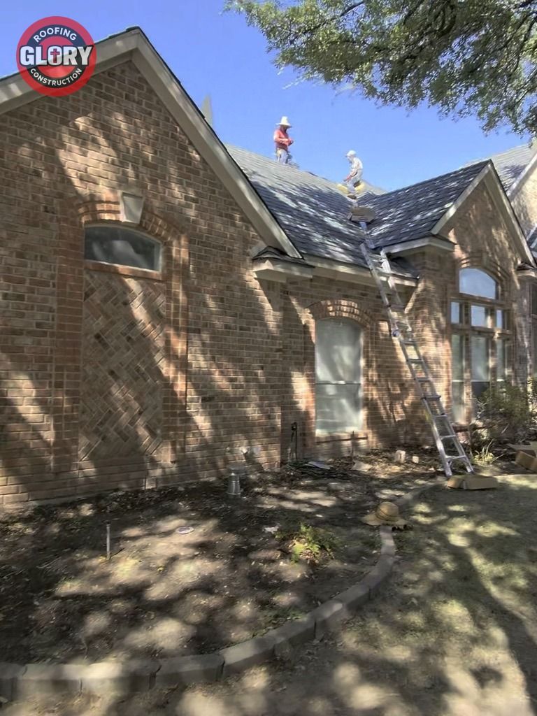 Roofing Glory crew replacing a roof on a brick home