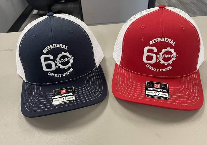 Navy and red OE Federal Credit Union 60th anniversary trucker hats