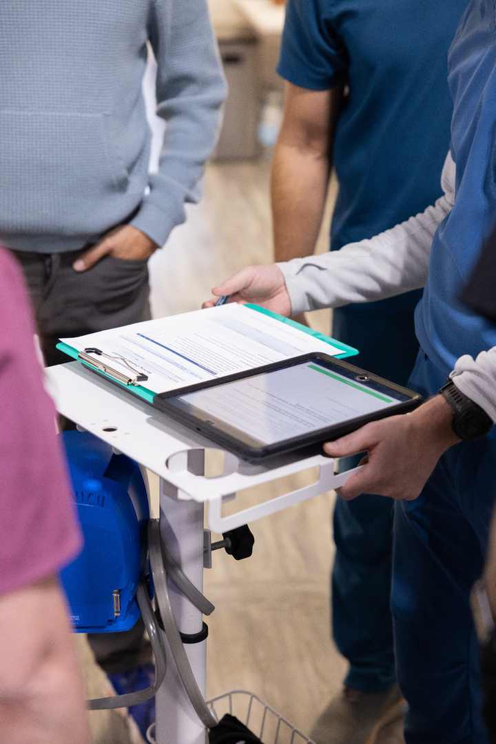 A training group reviewing practical hyperbaric procedures and documentation