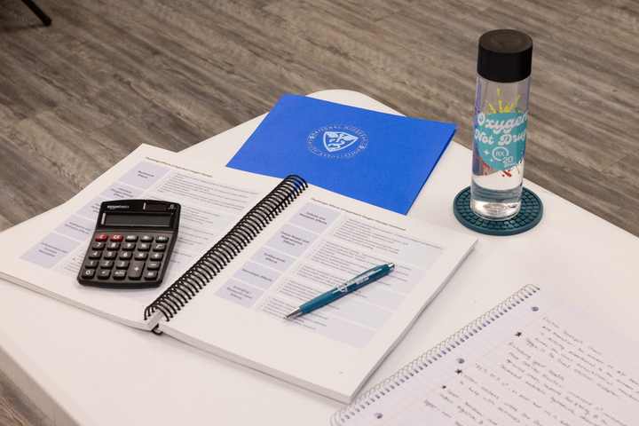 Course workbook, notes, and calculator arranged for hyperbaric training
