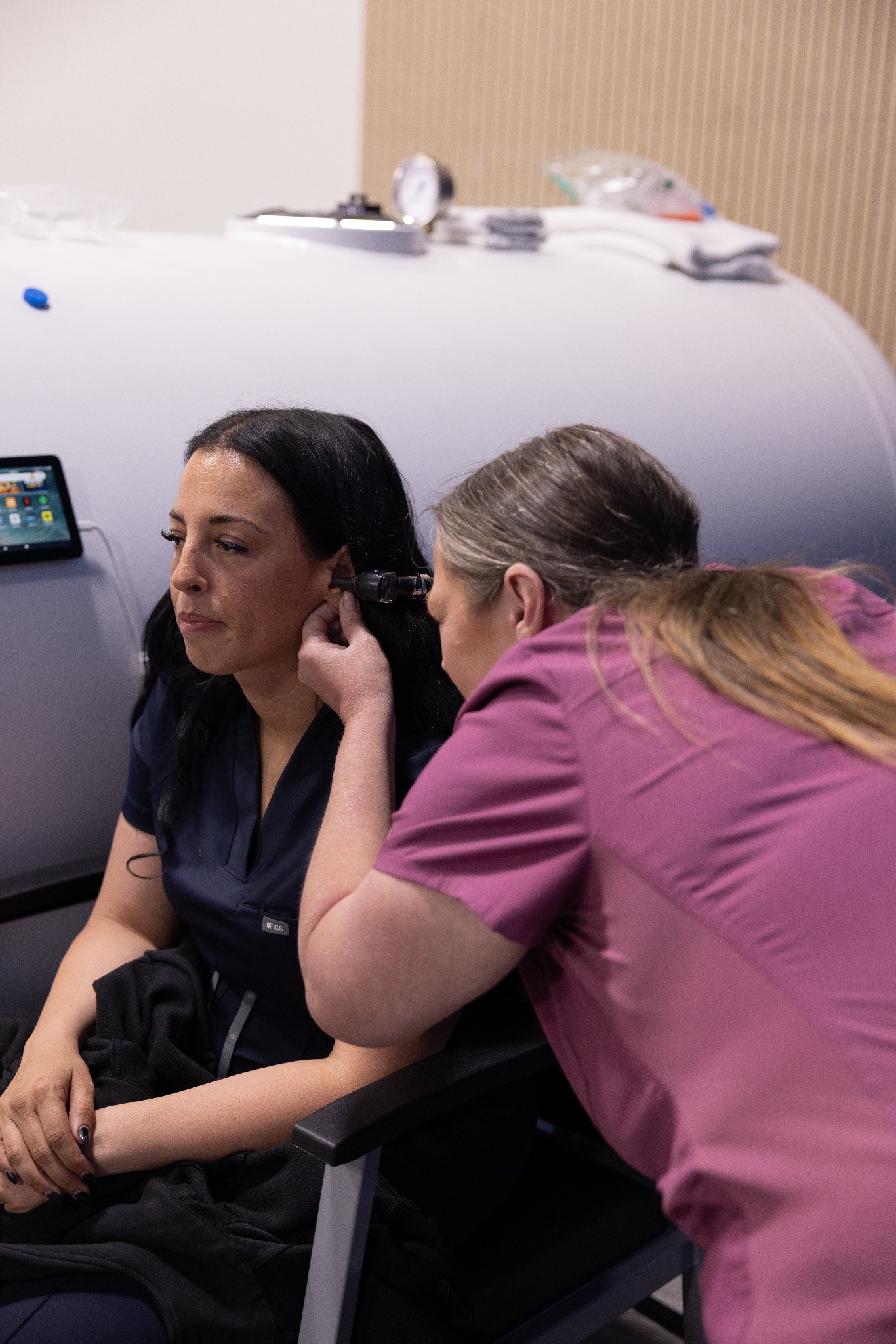 Cohort participants practicing an assessment beside a hyperbaric chamber