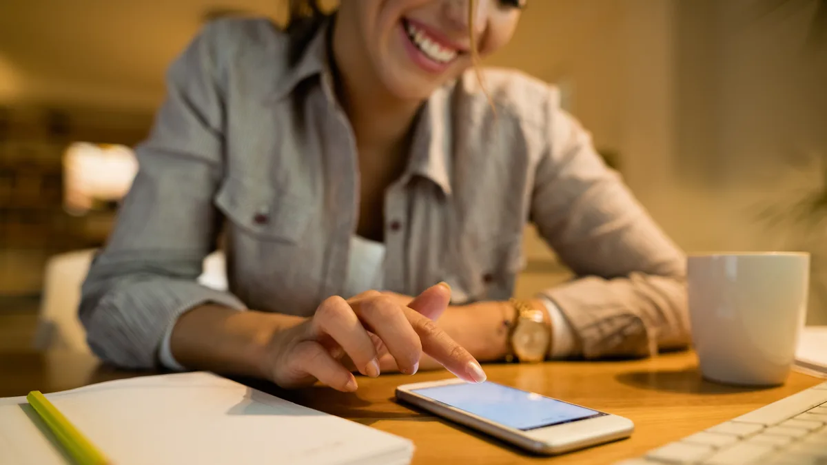 Homeowner using a smartphone at home.
