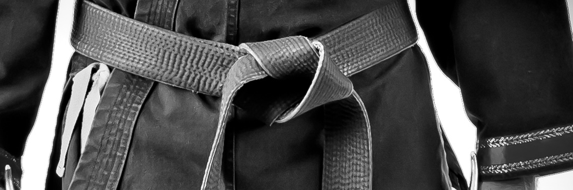 A close-up of a black belt during training