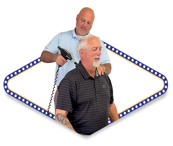 Dr. Dale Kimberlin performing a chiropractic treatment for an auto accident injury at Kimberlin Chiropractic located in Ankeny Iowa on a male patient using a chiropractic tool called an arthrostim.
