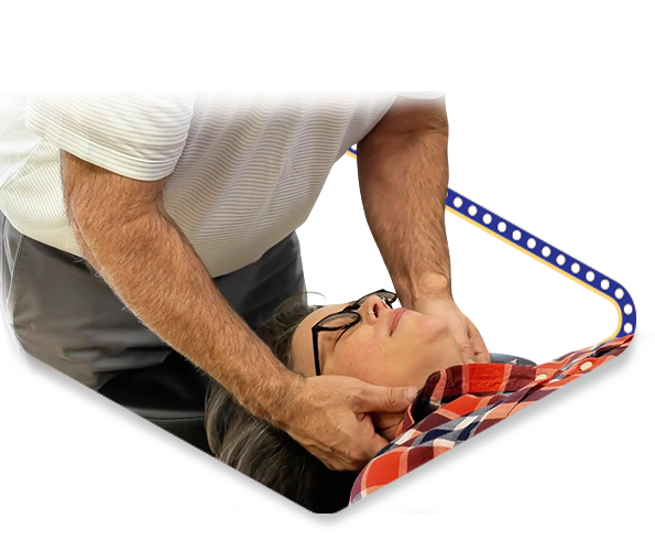 Dr. Dale Kimberlin adjusting a female chiropractic patient’s neck dealing with an auto accident injury at his Ankeny chiropractic office named Kimberlin Chiropractic Health Systems.