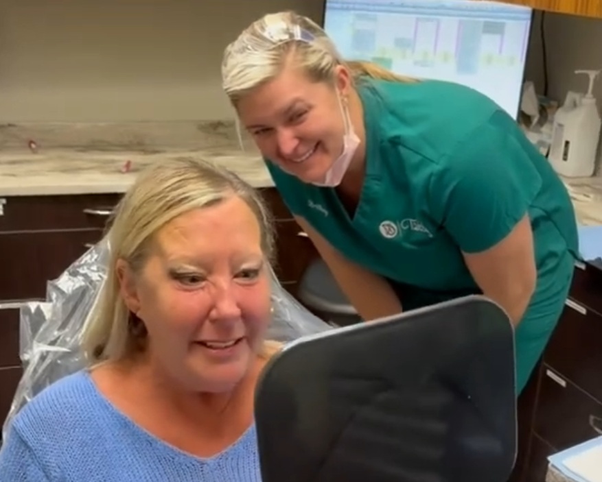 A Trinity Dental Arts patient smiling at their new teeth