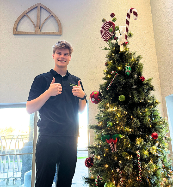 Metropolis Resort team member decorating the lobby for Christmas