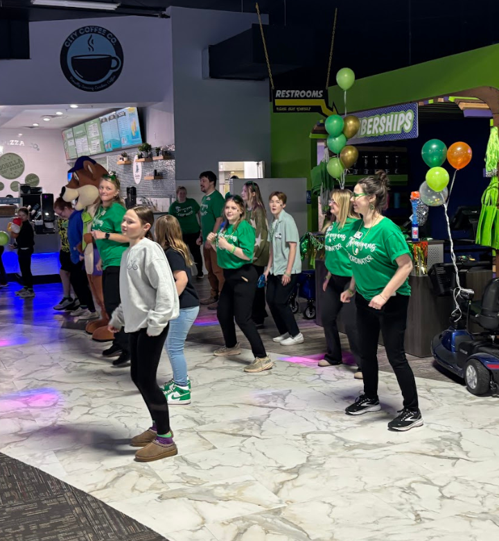 A young boy getting his face painted at Action City's St. Paddy's Day Party.
