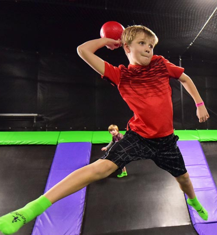 Boy playing dodgeball at the Action City Trampoline Park. Boy playing dodgeball at the Action City Trampoline Park.