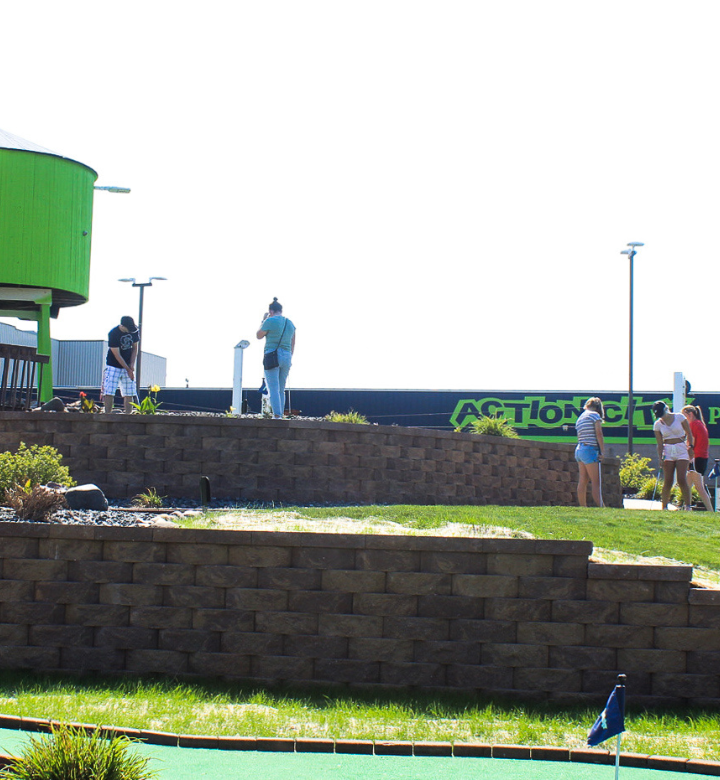Families mini golfing at Action City in Eau Claire, WI.