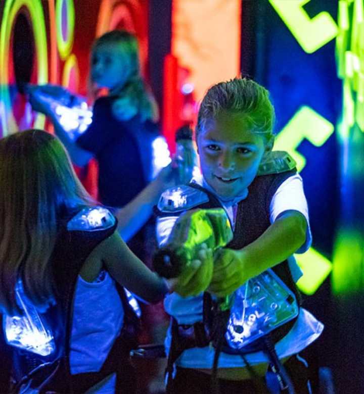 A young girl playing laser tag at Action City A young girl playing laser tag at Action City