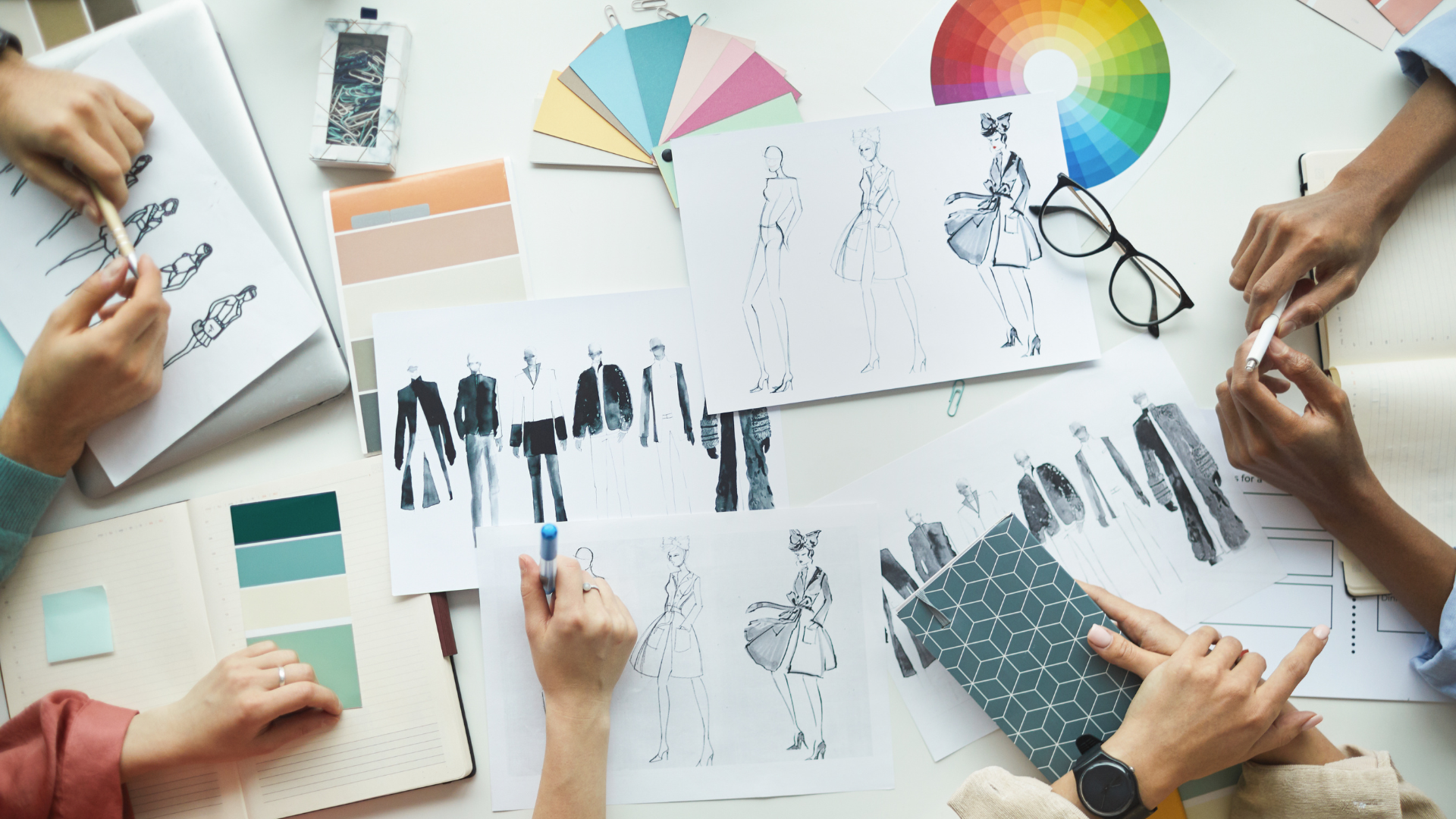 A collaborative design review of fashion sketches and product samples, illustrating the cross-functional readiness work behind a complete SB 707 checklist.