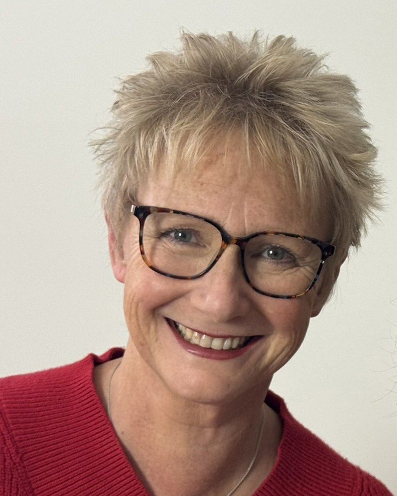 Kathryn Lovewell, smiling, in a red jumper