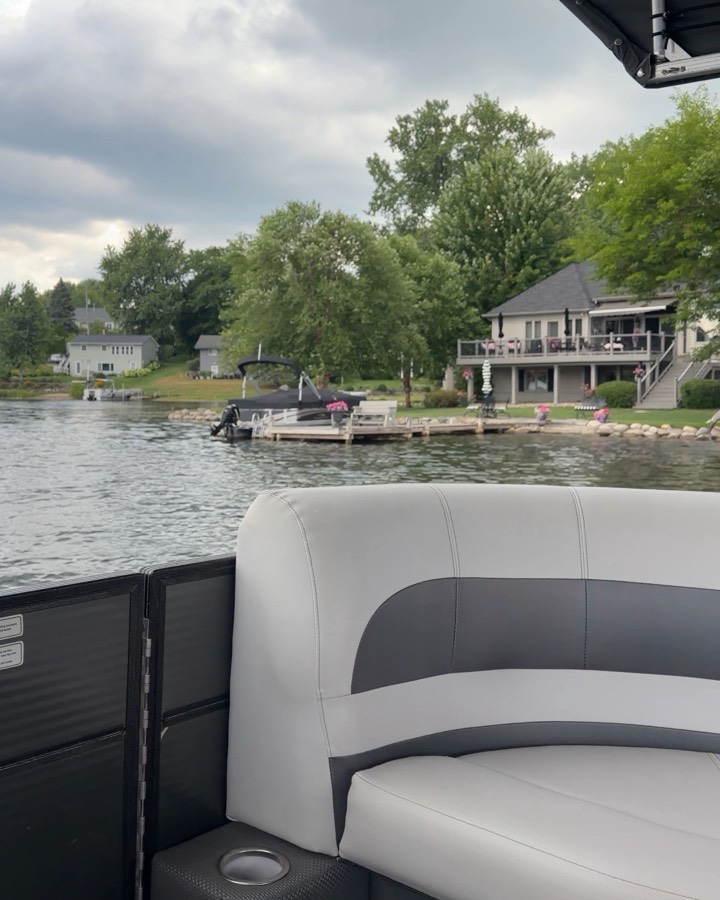 Lakefront homes and docks seen from a pontoon boat