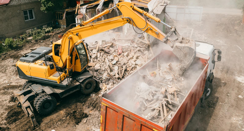 Excavator performing demolition work