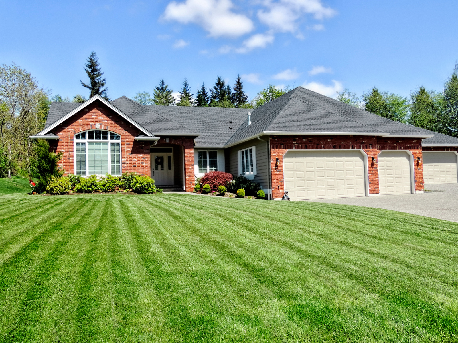 Full property shot showing a clean, well-maintained front yard