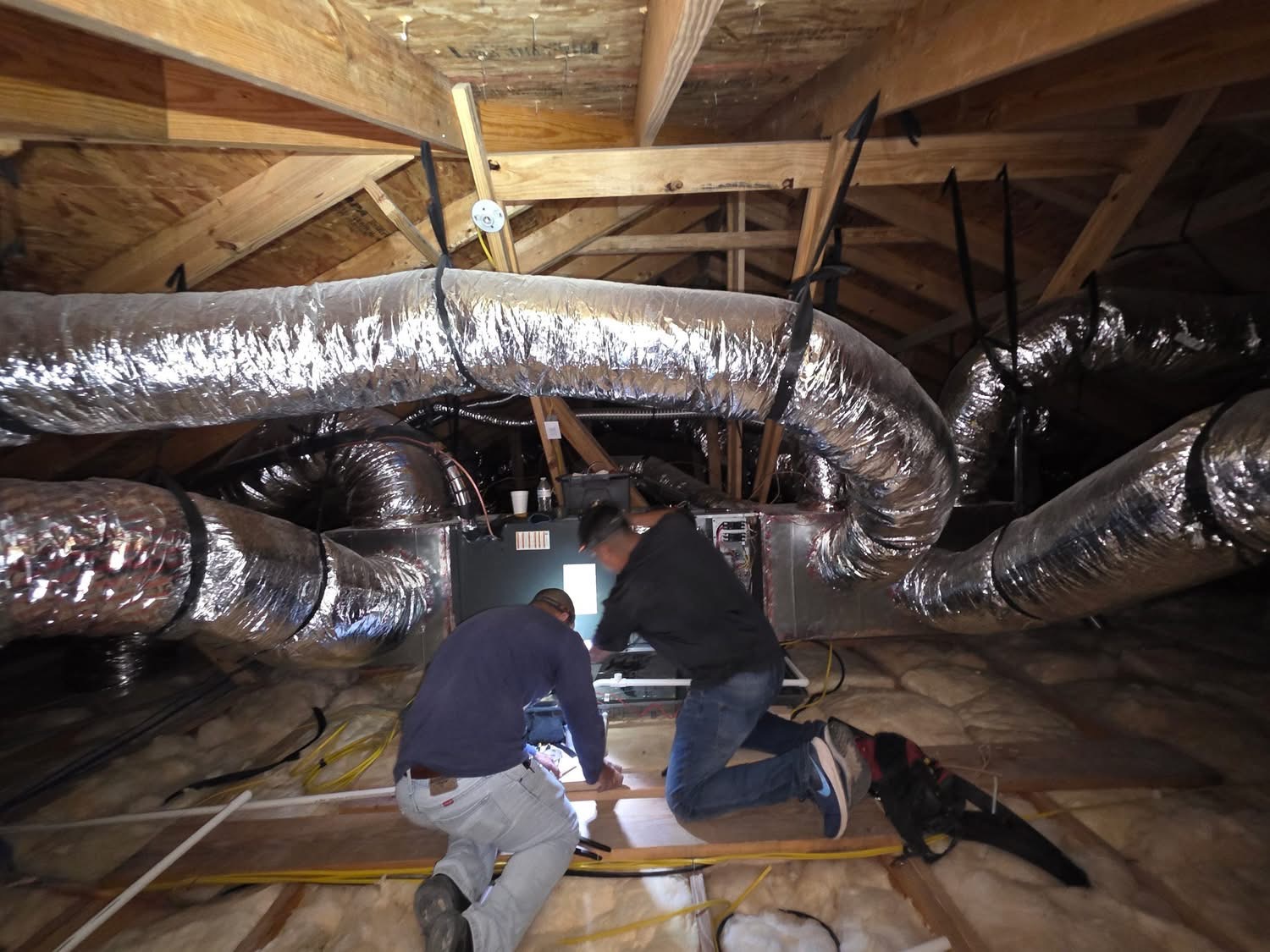HK Air Design technicians installing HVAC system