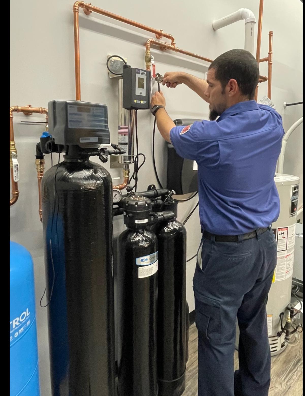 Technician diagnosing a water softener control valve during service visit