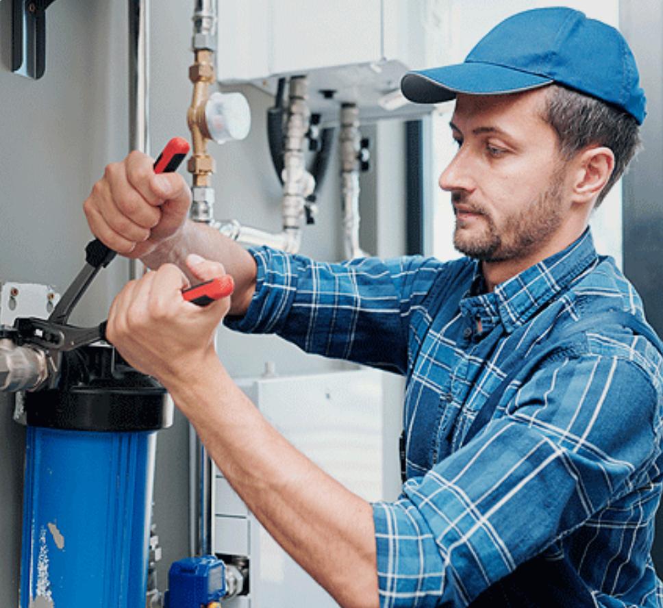 Technician replacing a water filter cartridge during maintenance service