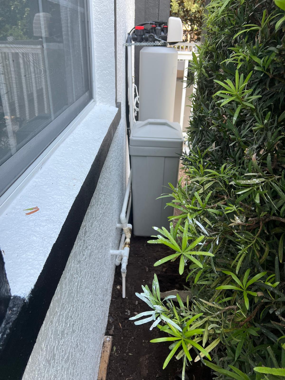 Professional plumber installing copper pipes for water filtration system