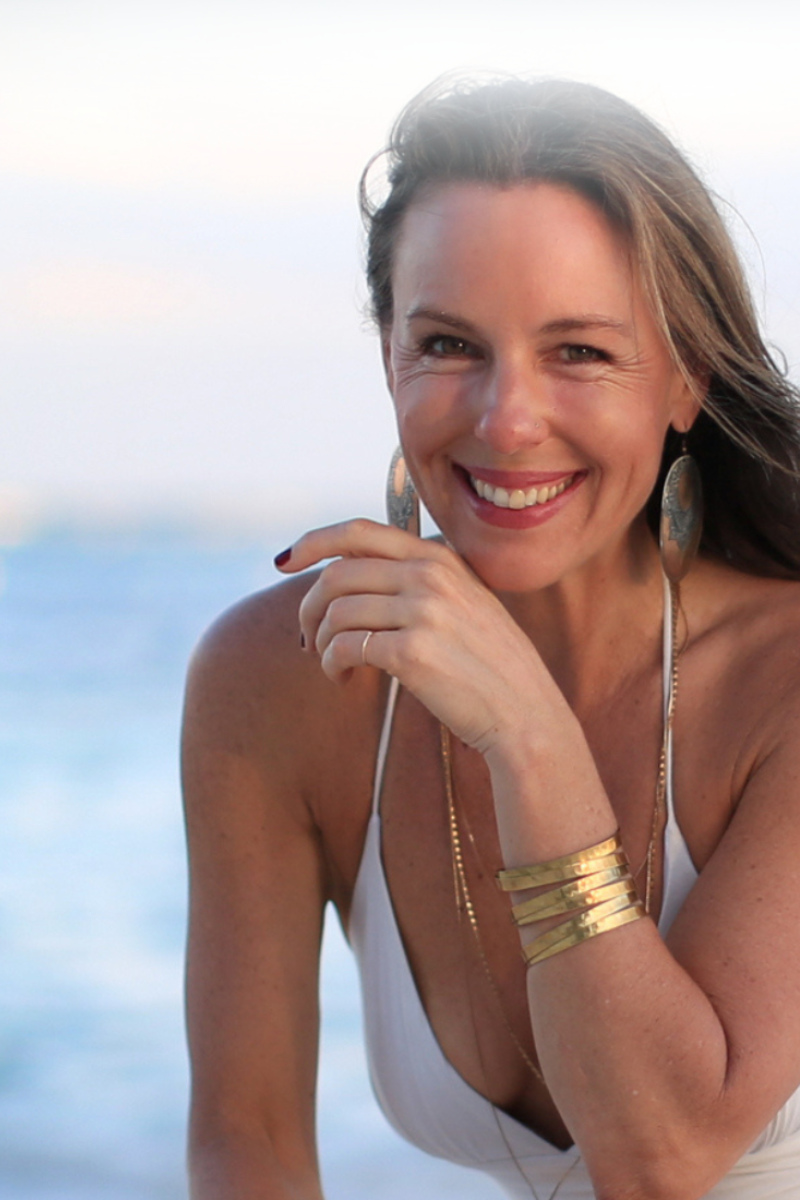 Dr. Erin Pollinger sitting in white dress