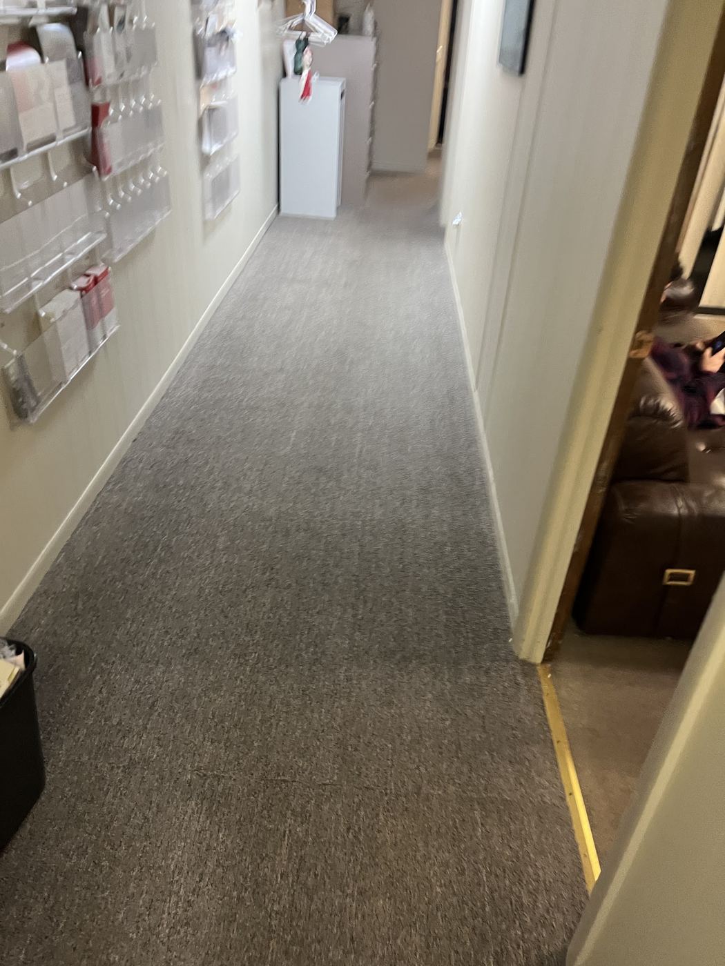 Long carpeted corridor vacuumed during commercial janitorial cleaning