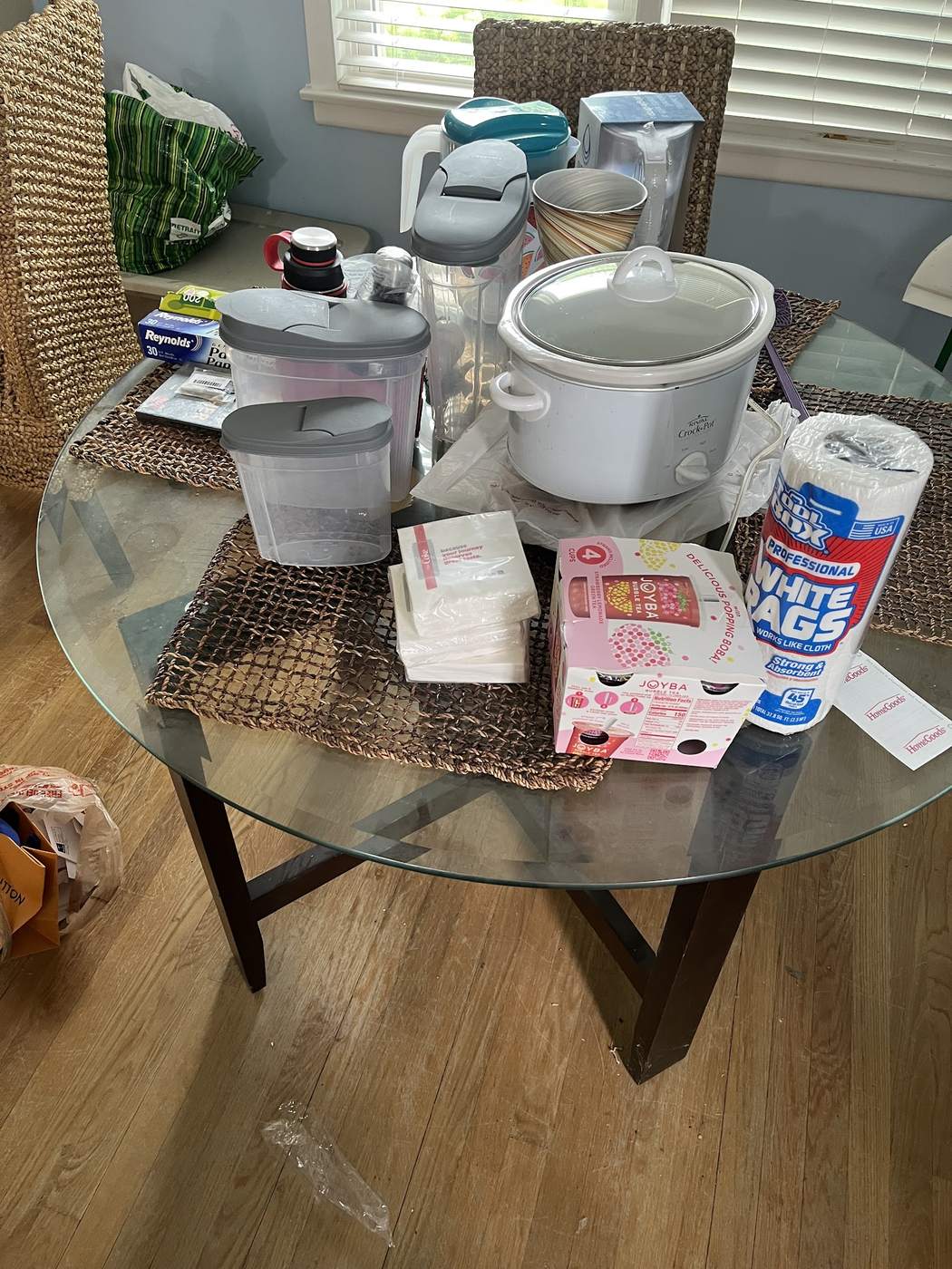 Cluttered dining table covered with household items before estate cleaning