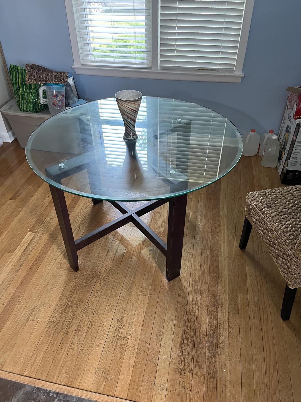 Cleared glass dining table on clean hardwood floor after estate cleaning