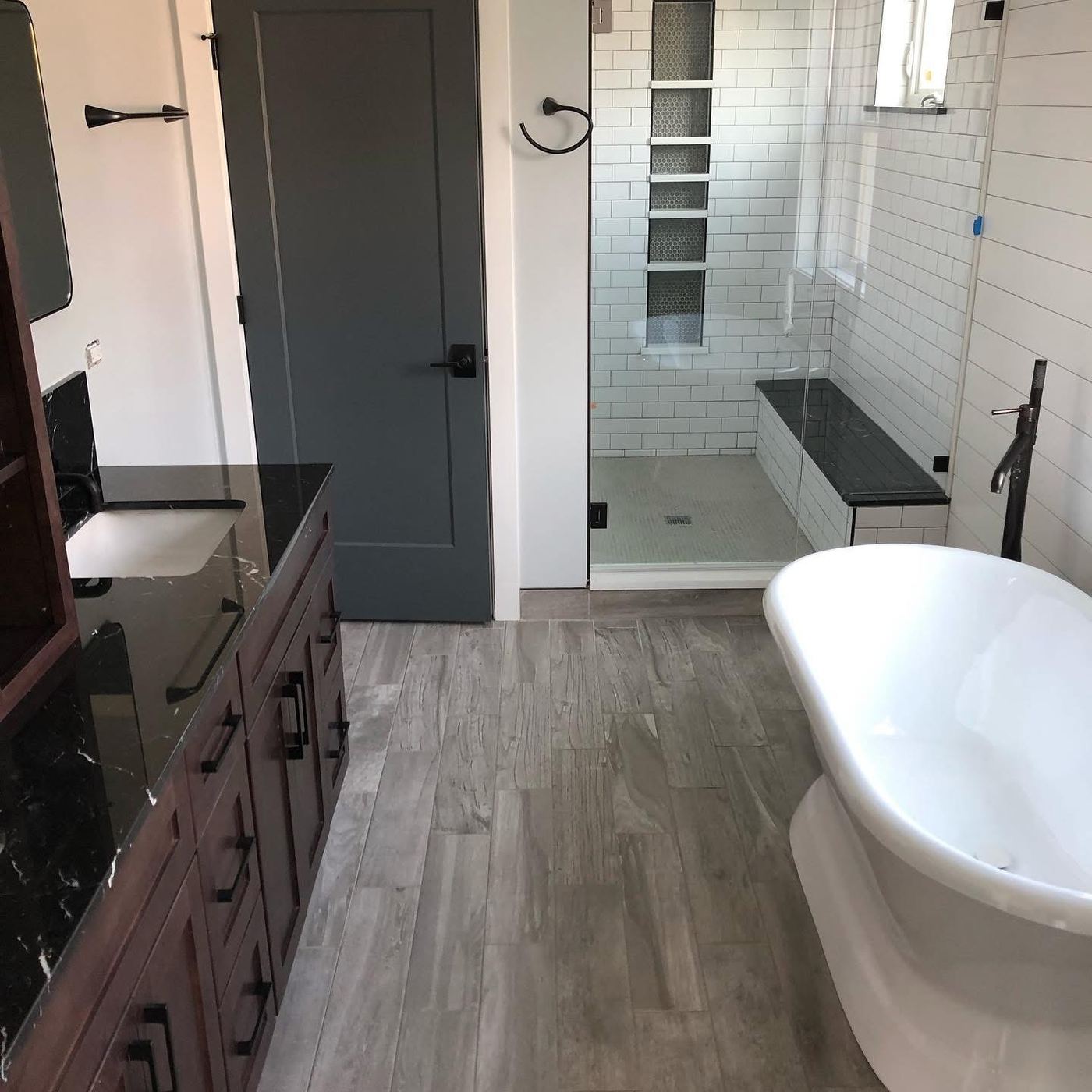 Renovated bathroom with freestanding tub and tiled shower after post-construction cleaning