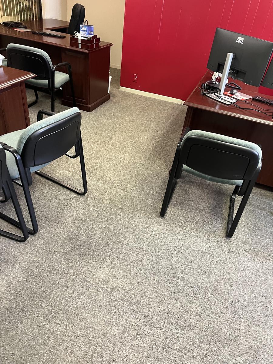 Private office with desks, chairs and vacuumed carpet after office cleaning