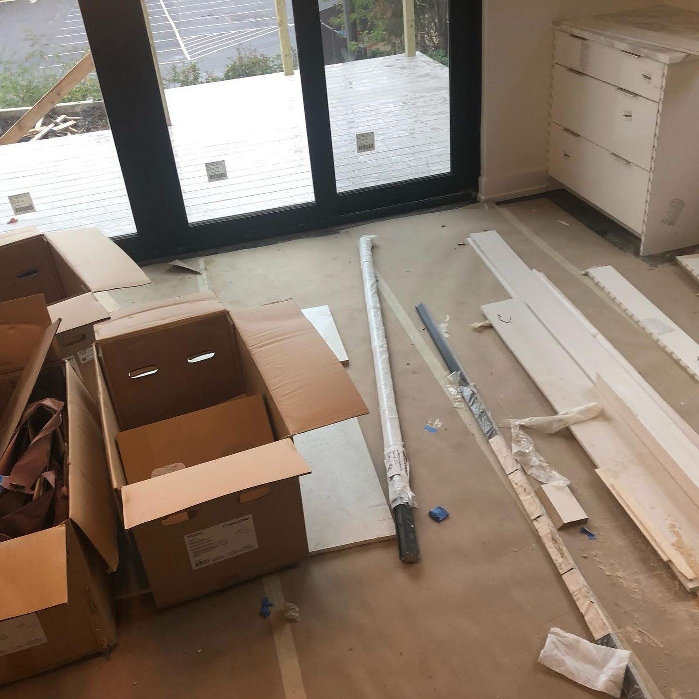 Construction debris and flooring boxes before post-construction cleaning