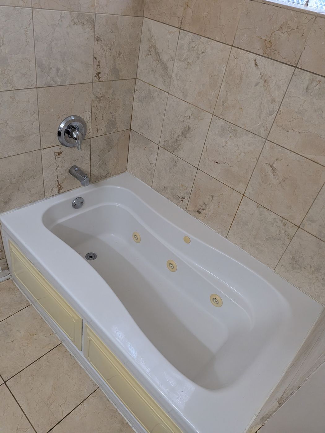 Jetted bathtub and tile surround cleaned in a rental unit