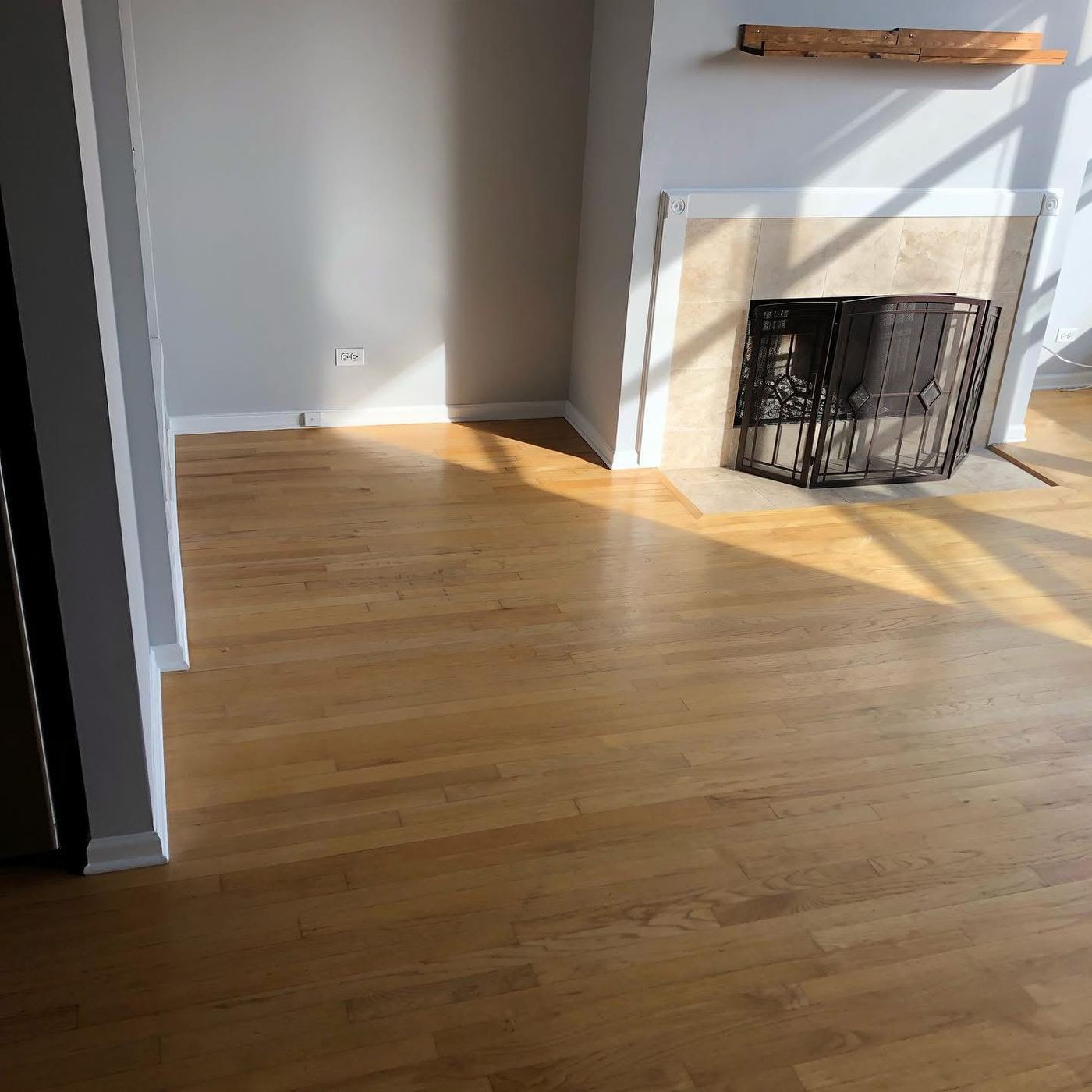 Listing-ready living room with clean hardwood floor and fireplace