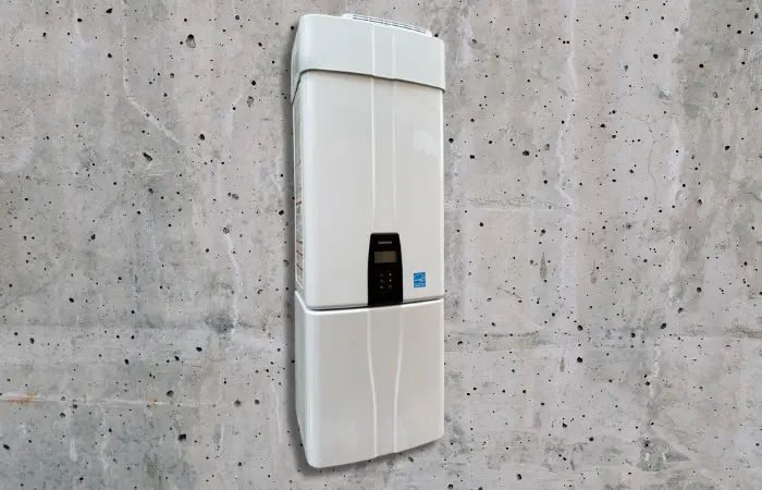 A white water heater installed on a cement wall. 