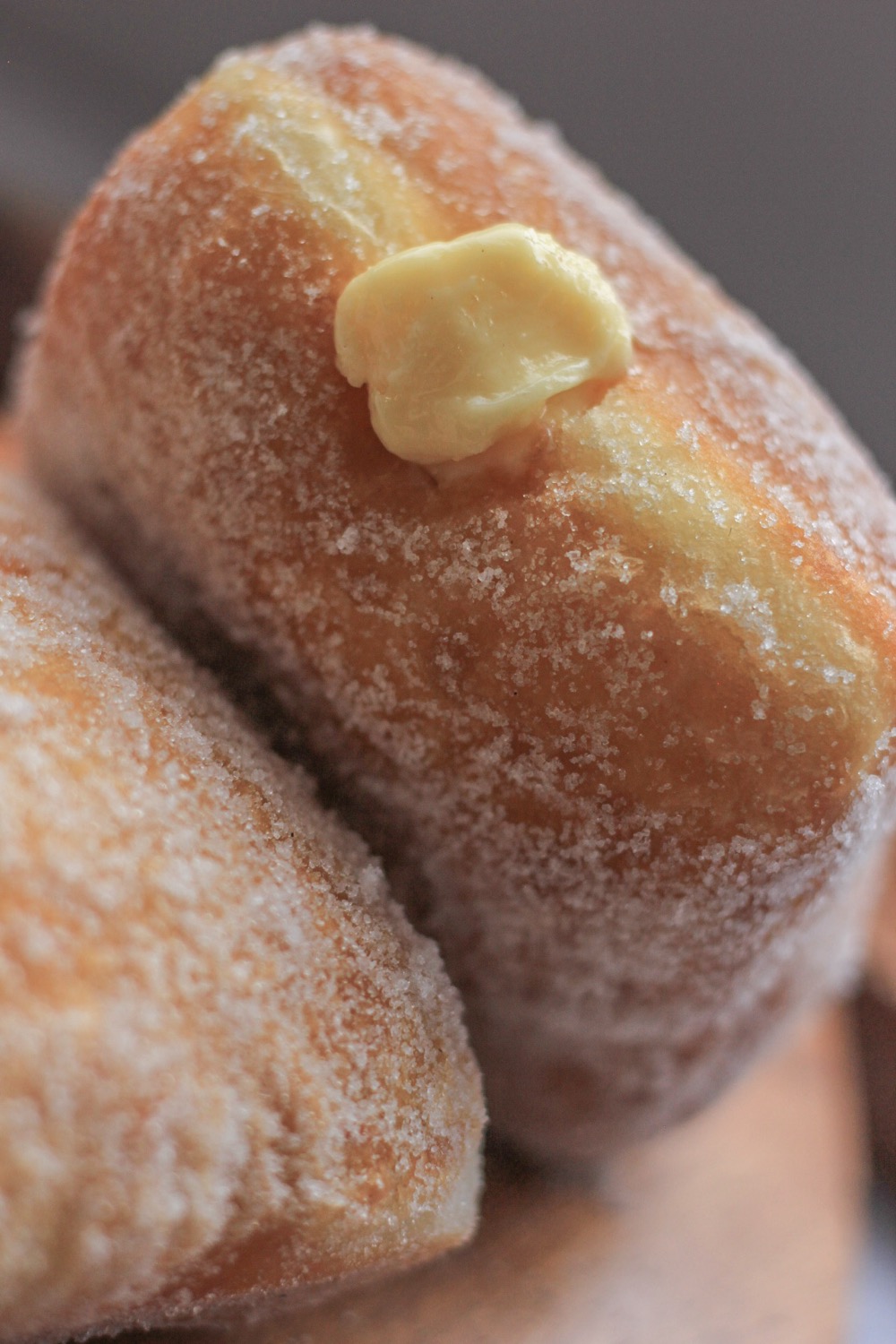 Sugar-rolled malasada with cream filling
