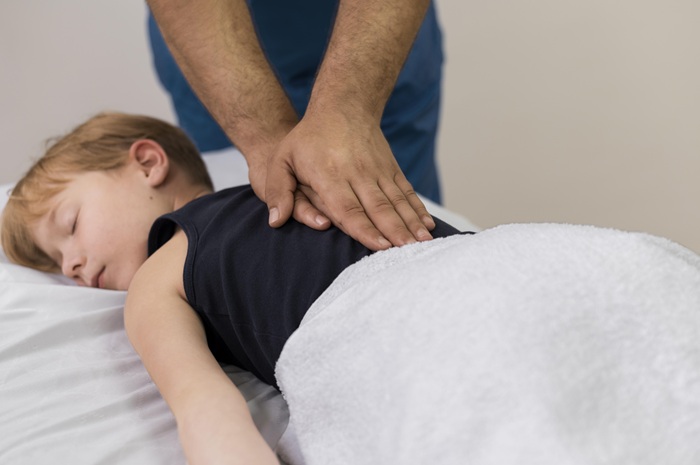 Chiropractor consulting with parent and child about pediatric chiropractic care in North Chesterfield VA