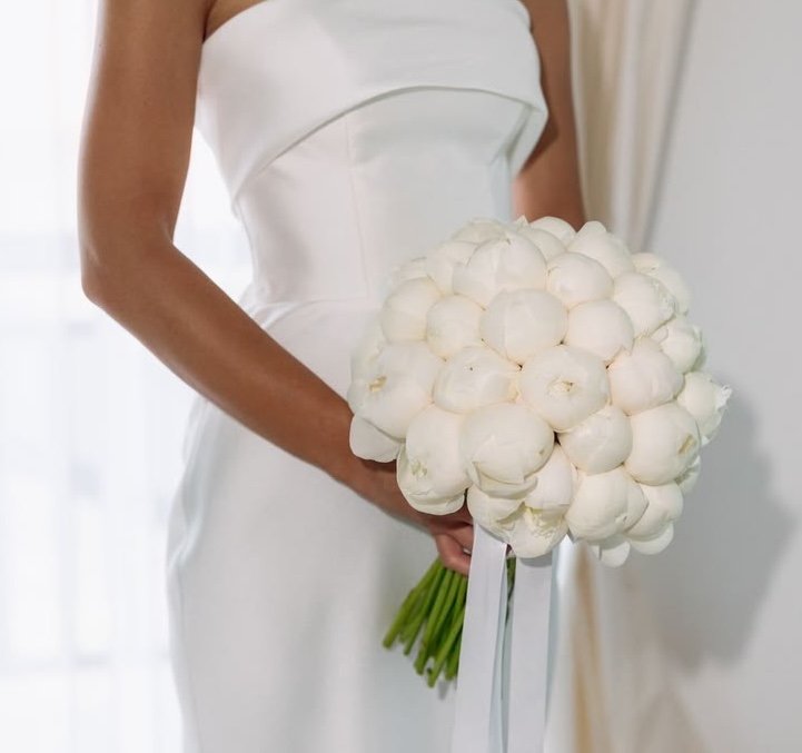 An elegant bridal arrangement of white and ivory blooms