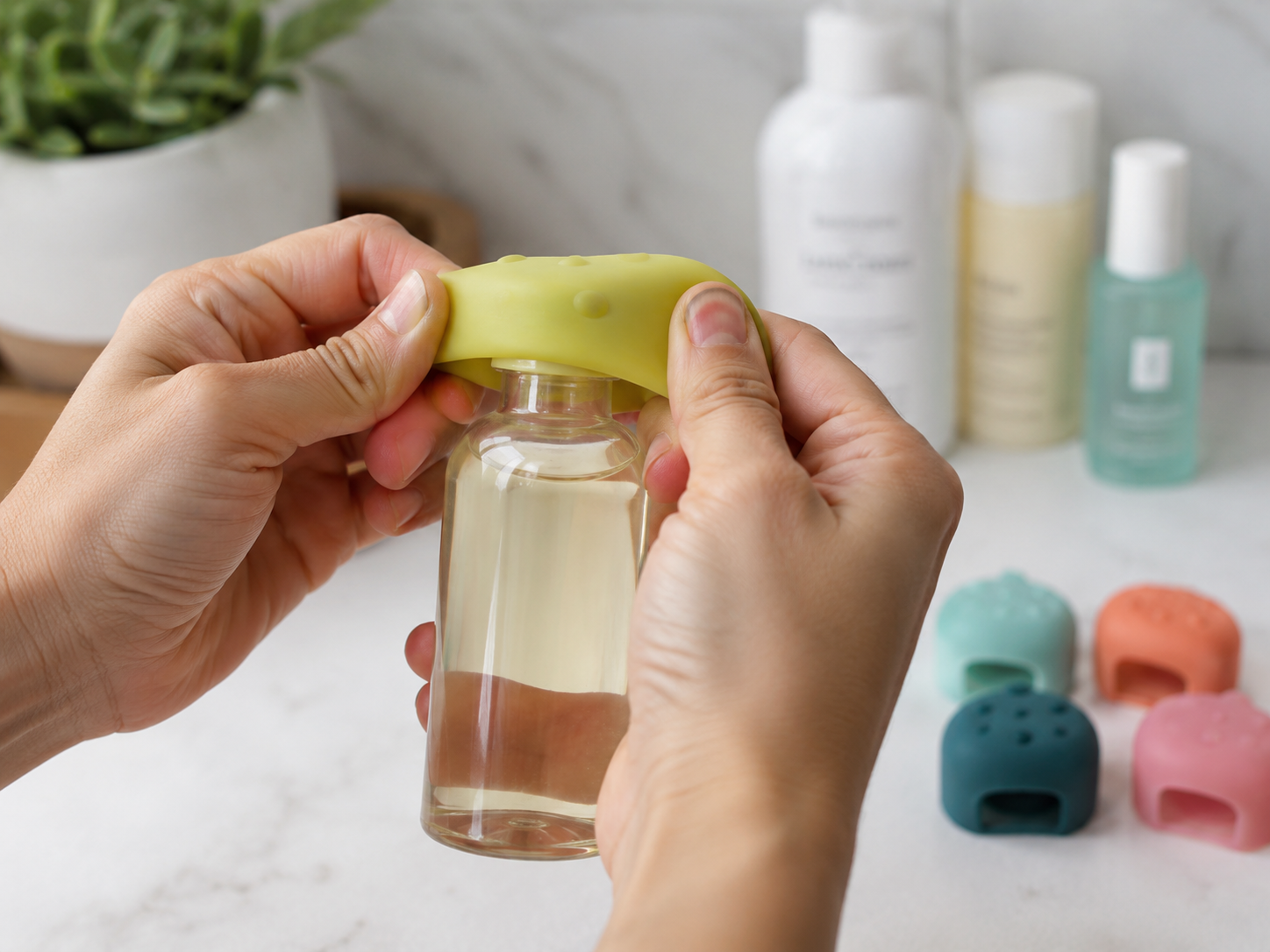 Silicone cover being stretched over a bottle