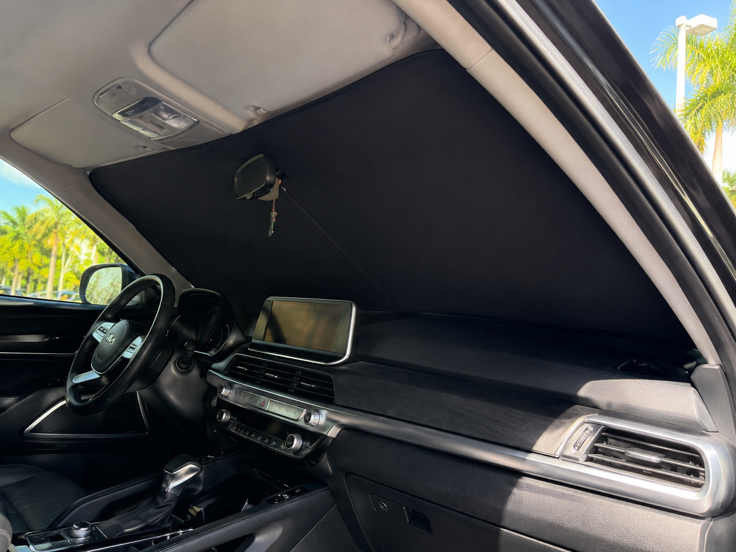 A close up of the sun shade material and fit against the windshield from inside the vehicle.