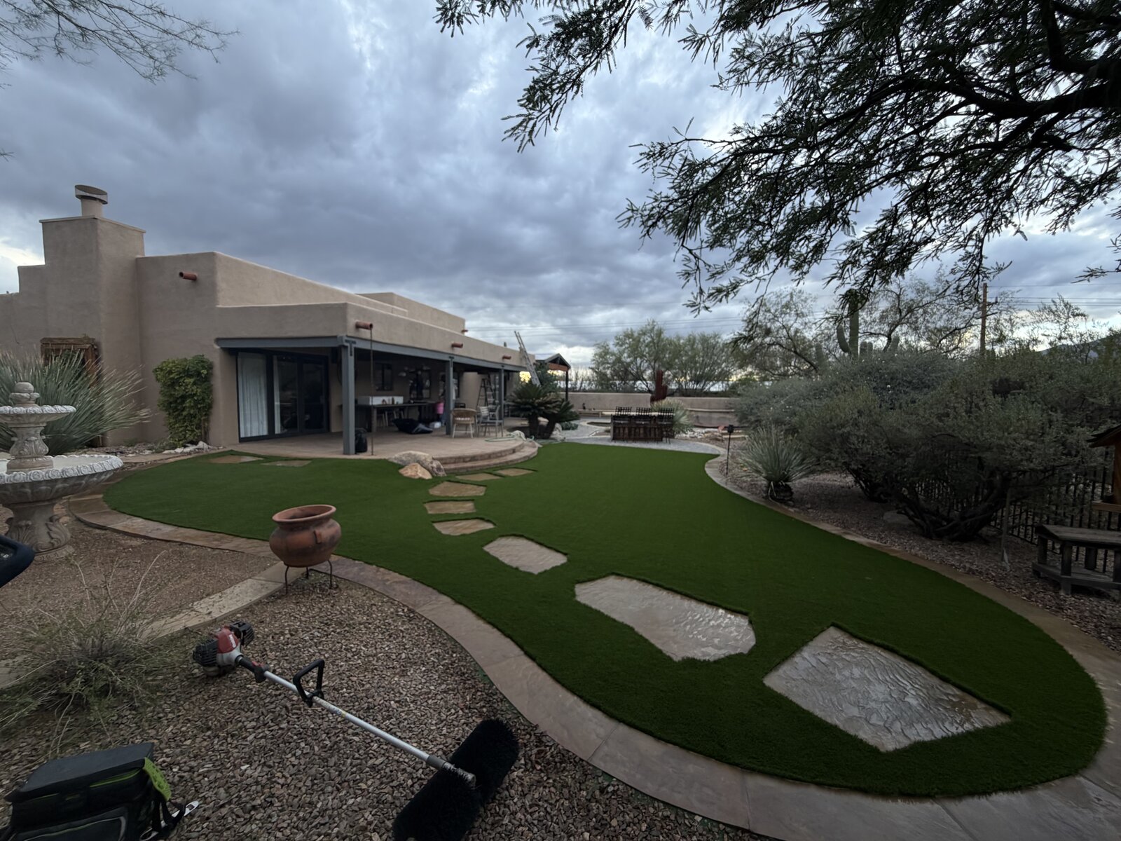 Same backyard finished, artificial turf and stepping stones