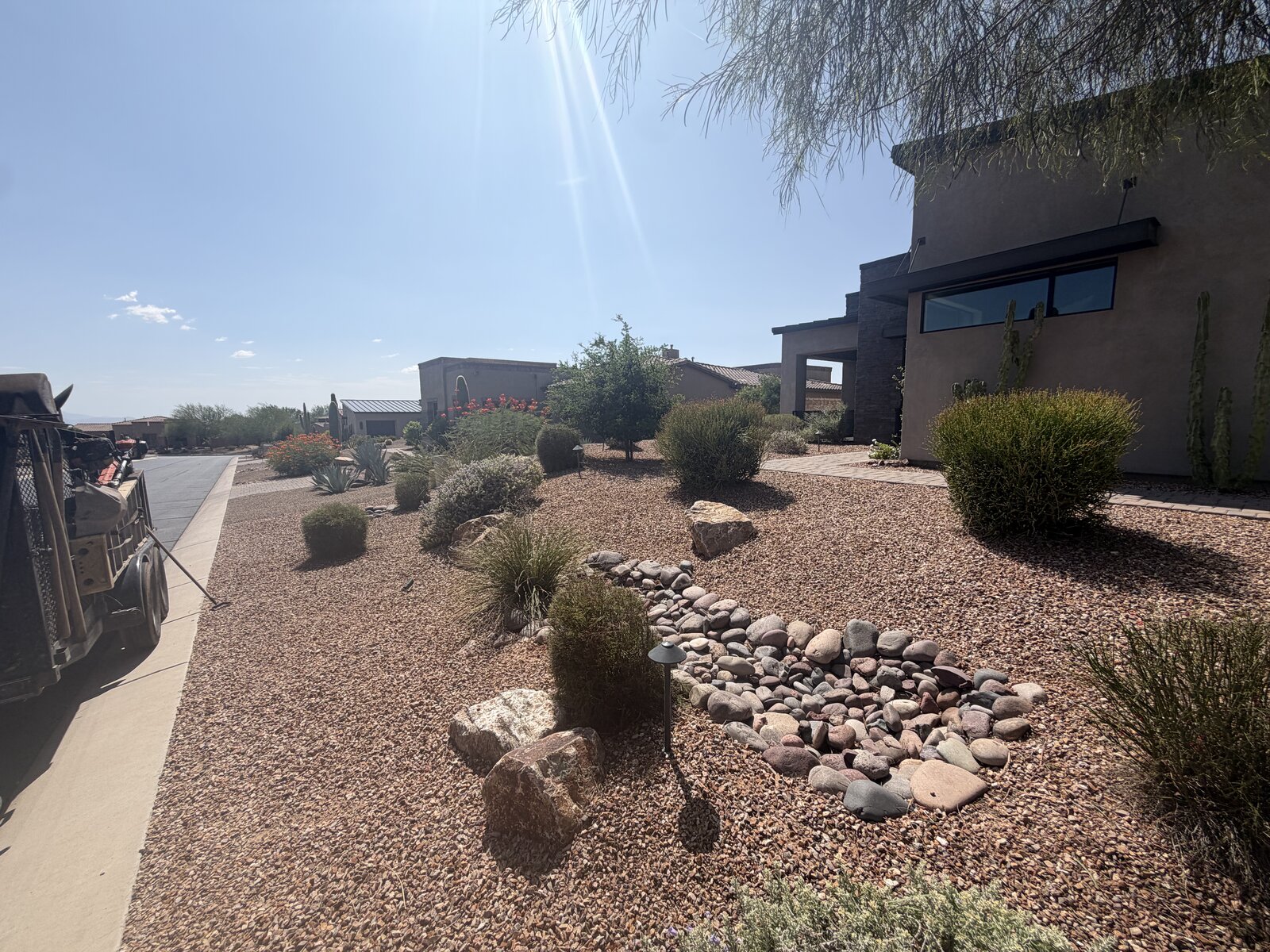 Front yard desert rock bed and dry riverbed feature