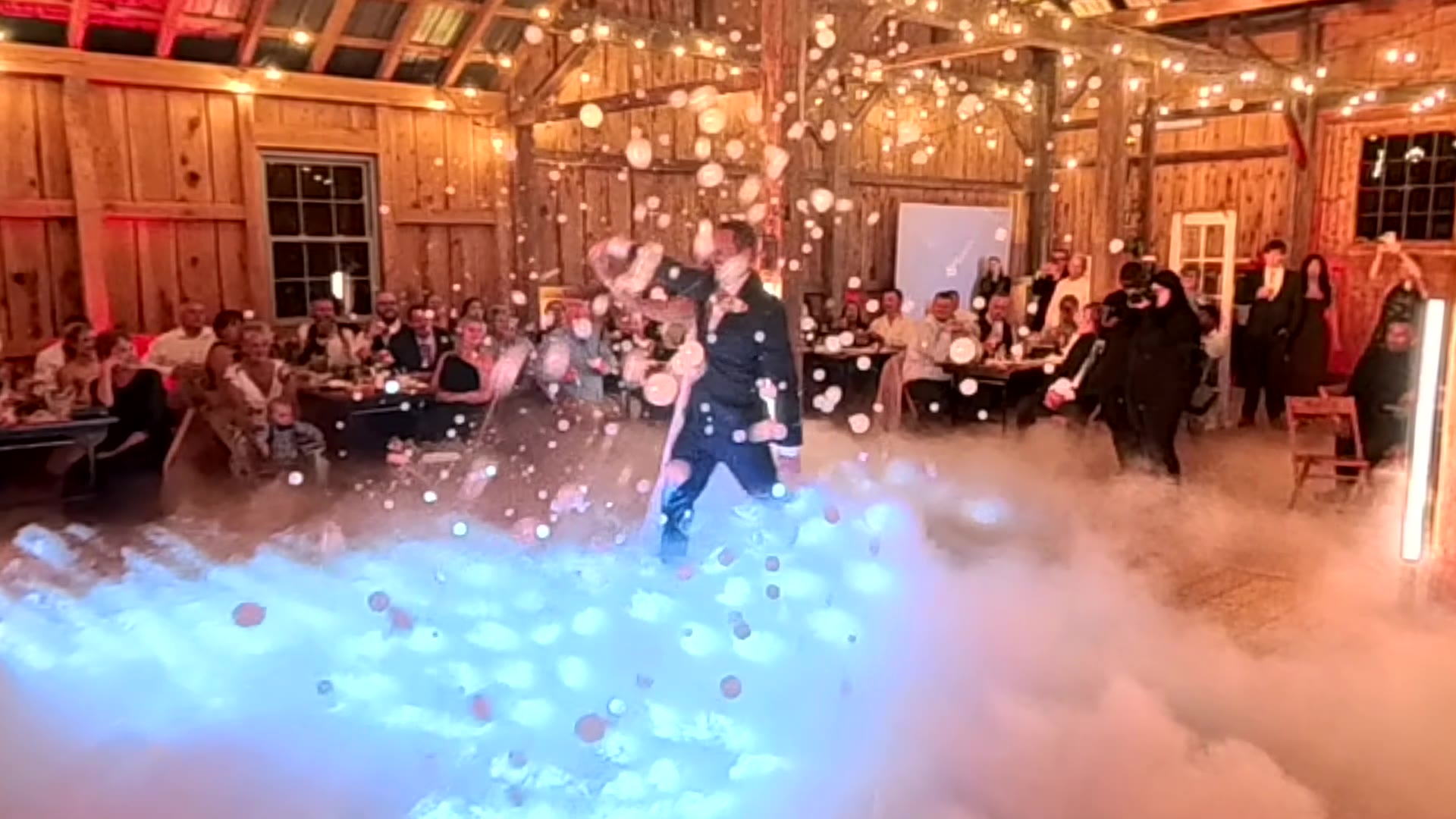 Couple sharing their first dance on a cloud of low fog