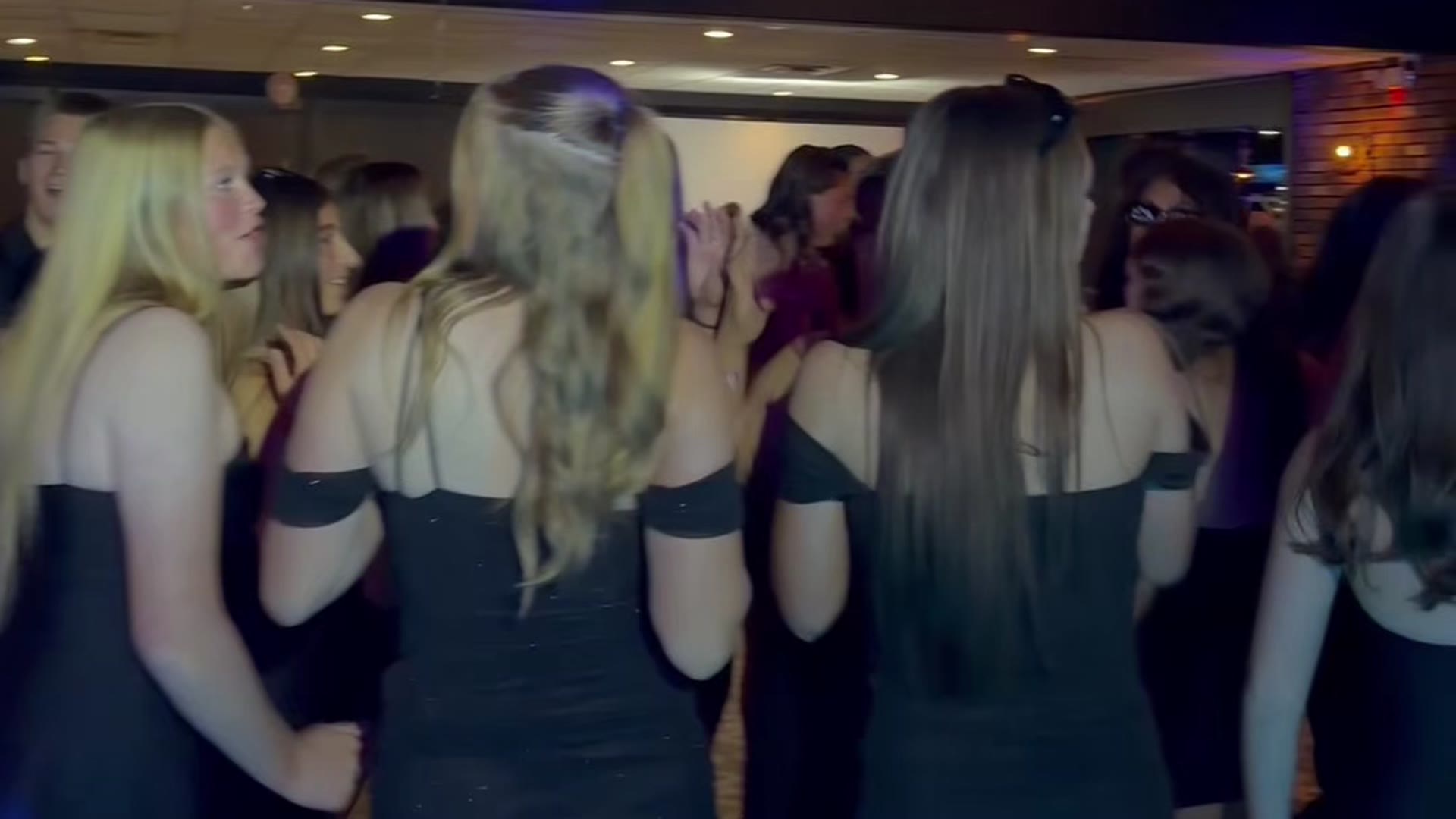Guests dancing on a packed dance floor at a private party