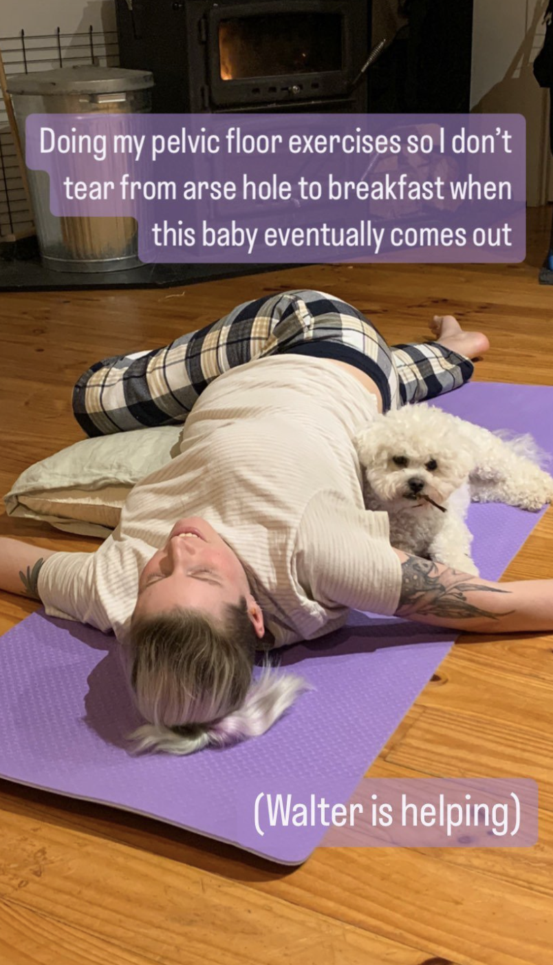 A a person lying on the floor with a white dog doing exercises. There's a fireplace in the background. A a person lying on the floor with a white dog doing exercises. There's a fireplace in the background.