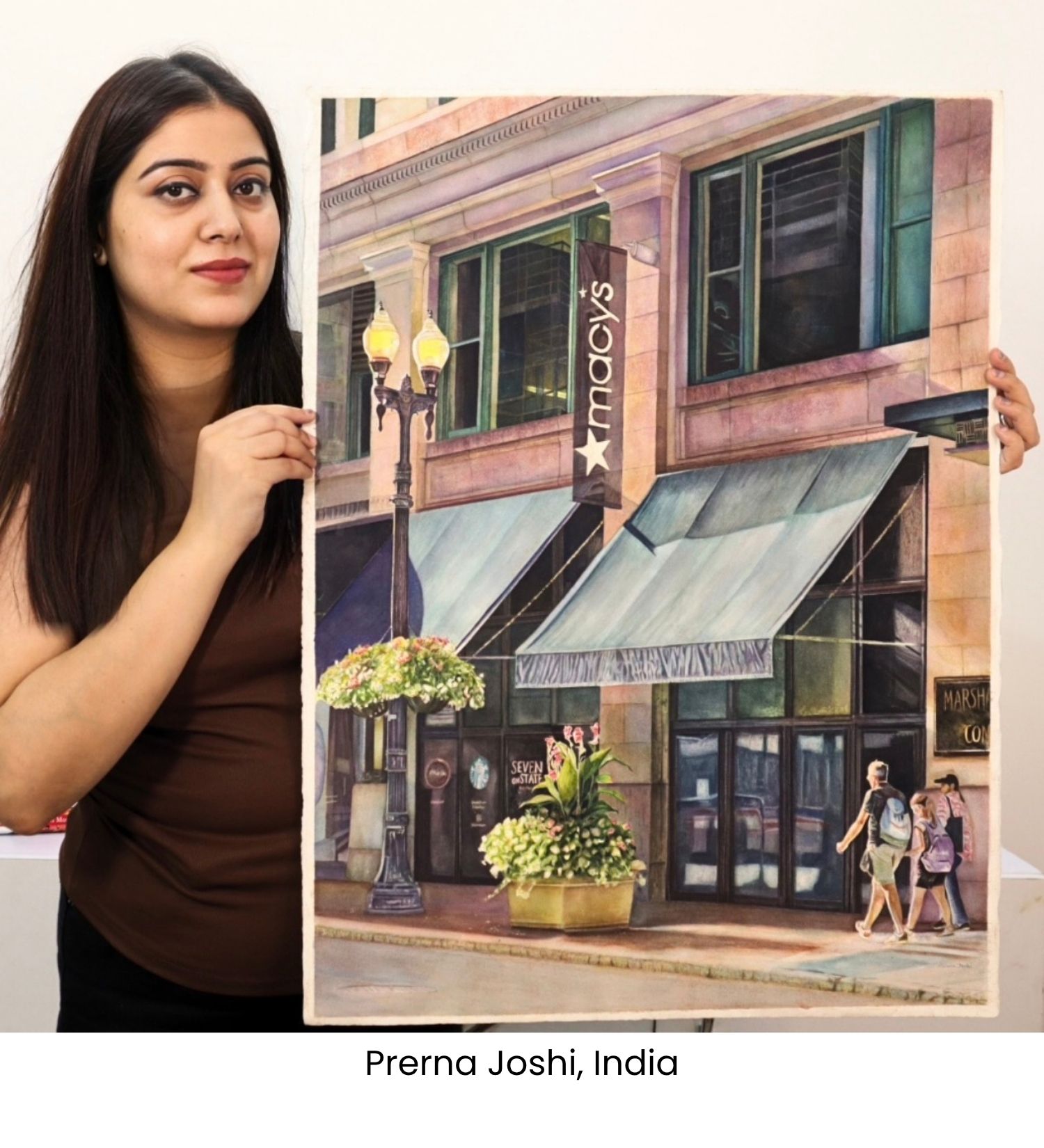 Prerna Joshi holding her Macy&rsquo;s storefront watercolor painting